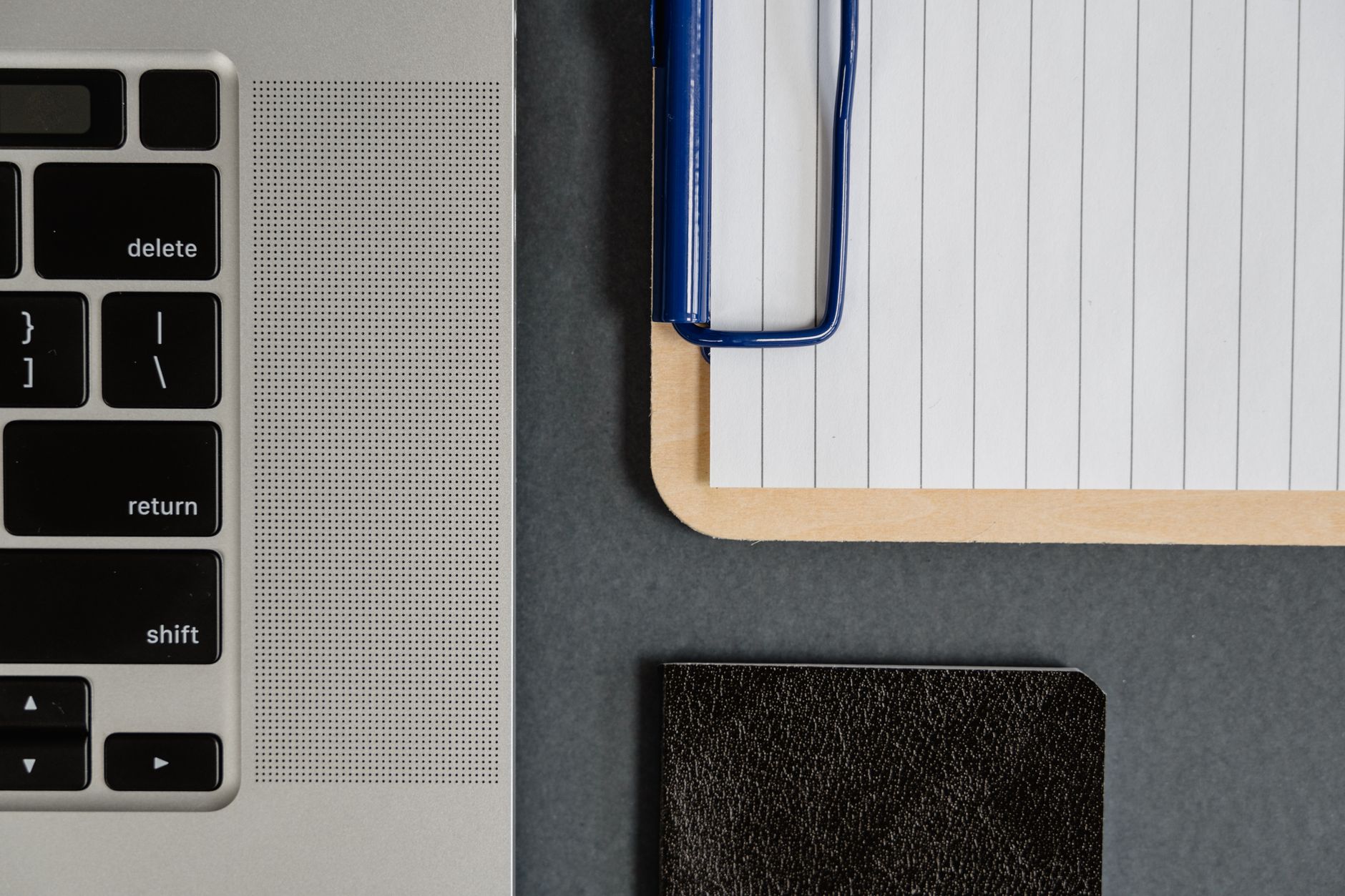 Written training notes beside a laptop
